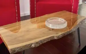 coastal finishes banner Live edge wooden table with glass bowl centerpiece.